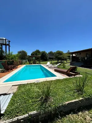 a swimming pool in the backyard of a house at Cabañas Dos Soles in Cordoba