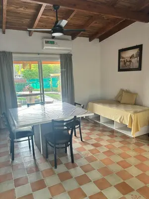 a room with a table and chairs and a bed at Cabañas Dos Soles in Cordoba