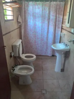 a bathroom with a toilet and a sink at Departamento NataFeli in Santa Rosa de Calamuchita