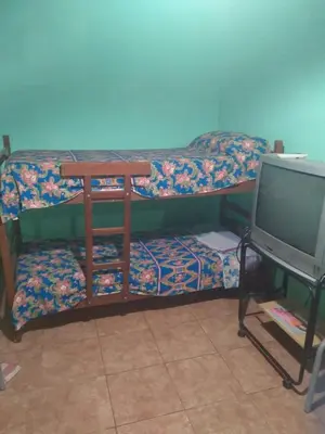 a bunk bed with a desk and a tv at Departamento NataFeli in Santa Rosa de Calamuchita