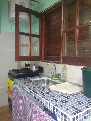 a kitchen counter with a sink and a stove at Departamento NataFeli in Santa Rosa de Calamuchita