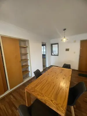 a dining room with a wooden table and chairs at Dpto p 3 en pleno Nva. Córdoba in Cordoba