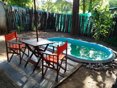 a table and chairs next to a swimming pool at Cheroga in Trapiche