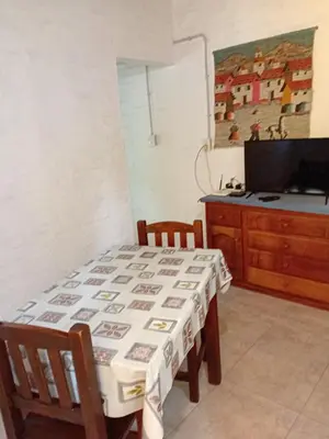 a dining room with a table and a television at Cheroga in Trapiche