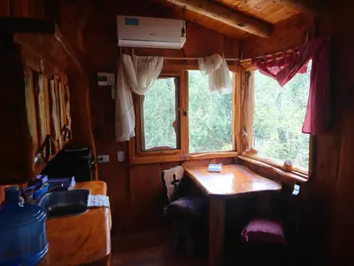 a small room with a table and a window at La Cabañita in Tanti
