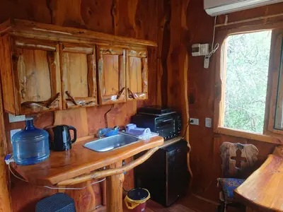 a kitchen with a sink and a microwave at La Cabañita in Tanti
