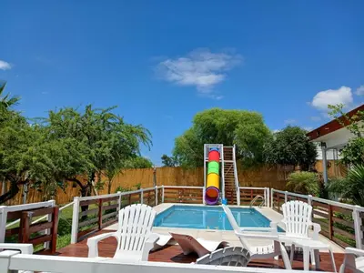 a swimming pool with chairs and a inflatable at Atardeceres del Valle in La Bolsa