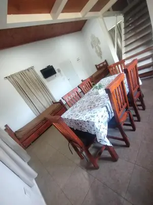 a table and four chairs in a room at Atardeceres del Valle in La Bolsa