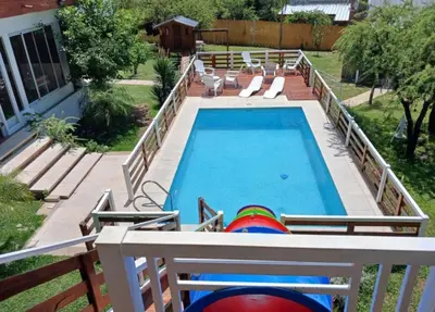 a swimming pool with lounge chairs and a swimming pool at Atardeceres del Valle in La Bolsa