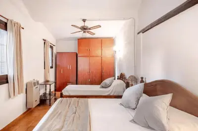a bedroom with two beds and a ceiling fan at Hermosa Casa V. General Belgrano in Villa General Belgrano