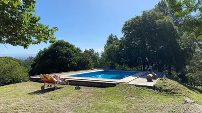 a swimming pool on top of a hill with trees at Hermosa Casa V. General Belgrano in Villa General Belgrano