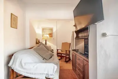 a bedroom with a bed and a television in a room at Hermosa Casa V. General Belgrano in Villa General Belgrano