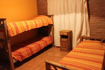 a bedroom with two bunk beds and a window at Cabañas Las Marias 1 in Cordoba