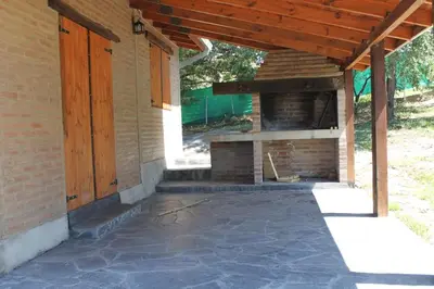 an outdoor patio with a brick oven on the side of a house at Cabañas Las Marias 1 in Cordoba