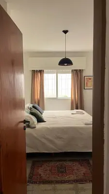 a bedroom with a bed and a window at Casa Raíz 2 habitaciones para 4 personas frente al río in Santa Rosa de Calamuchita