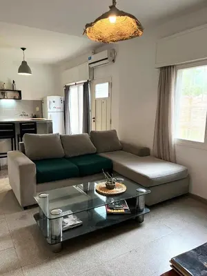 a living room with a couch and a table at Casa Raíz 2 habitaciones para 4 personas frente al río in Santa Rosa de Calamuchita