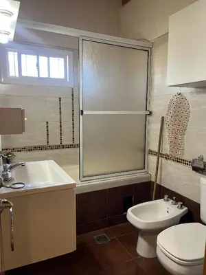 a bathroom with a toilet and a sink at Casa Beethoven in Villa Carlos Paz
