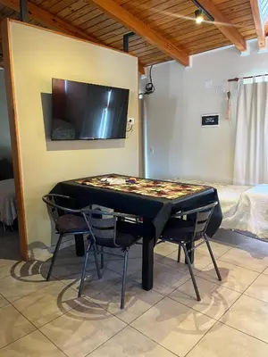 a ping pong table in a room with two chairs at Casa Beethoven in Villa Carlos Paz