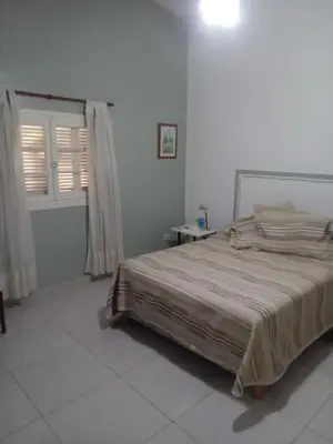 a bedroom with a large bed in a white room at DAS THOMY II in Cordoba