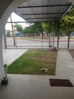 an open courtyard with a fence and a grass field at DAS THOMY II in Cordoba