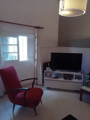 a living room with a flat screen tv and a chair at DAS THOMY II in Cordoba