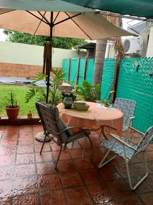 a table and chairs with an umbrella on a patio at DAS THOMY II in Cordoba
