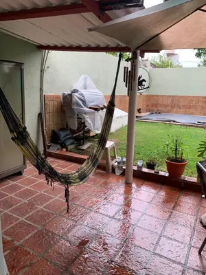 a hammock on a patio with an umbrella at DAS THOMY II in Cordoba