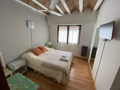 a small bedroom with a bed and a window at Hotel Prater in Villa General Belgrano