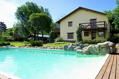 a large swimming pool in front of a house at la matilda in Santa Rosa de Calamuchita
