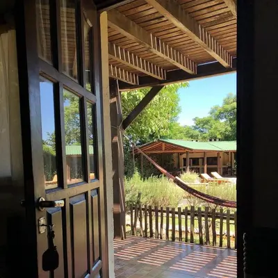 an open door to a porch with a hammock at la matilda in Santa Rosa de Calamuchita