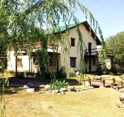 a house with a picnic bench in front of it at la matilda in Santa Rosa de Calamuchita