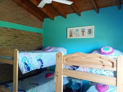 two bunk beds in a room with blue walls at Casa Erica in Santa Rosa de Calamuchita