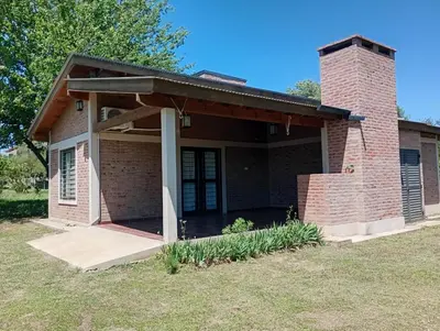 a small brick house with a porch at Casa Erica in Santa Rosa de Calamuchita