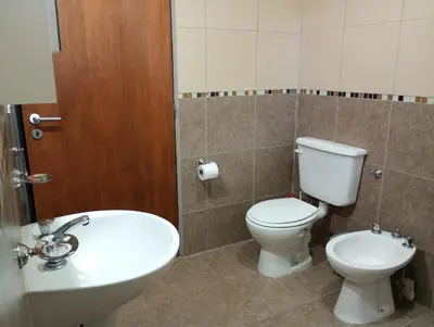 a bathroom with a toilet and a sink at Casa Erica in Santa Rosa de Calamuchita