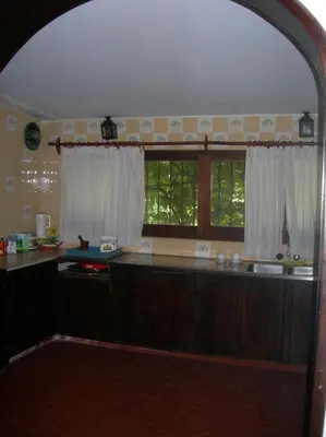 a kitchen with a large counter and two windows at Tunquelen in Las Calles