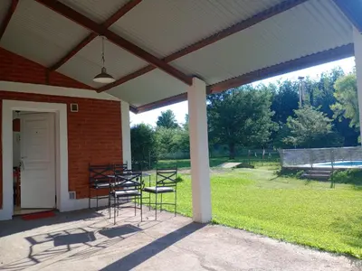 a patio with chairs and a table and a building at Shakty 