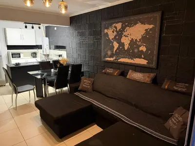 a living room with a couch and a table at Departamento c/ piscina climatizada privada, 4 habitaciones en el centro de Cordoba in Cordoba