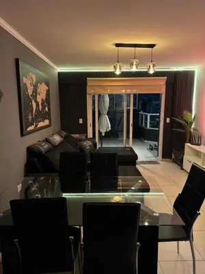 a living room with a glass table and a couch at Departamento c/ piscina climatizada privada, 4 habitaciones en el centro de Cordoba in Cordoba