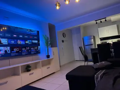 a living room with a large flat screen tv at Departamento c/ piscina climatizada privada, 4 habitaciones en el centro de Cordoba in Cordoba