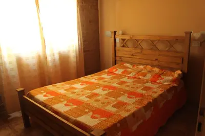 a bedroom with a bed with a quilt on it at Cabaña Las Marias 4 in Cordoba