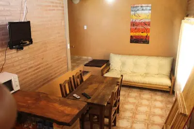 a living room with a table and a couch at Cabaña Las Marias 4 in Cordoba