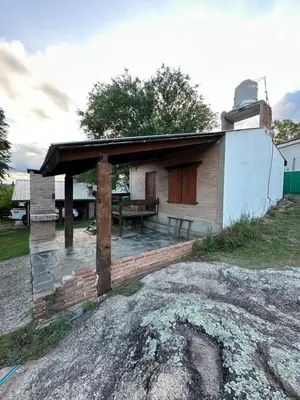 a small house with a patio and a table at Cabaña Las Marias 4 in Cordoba