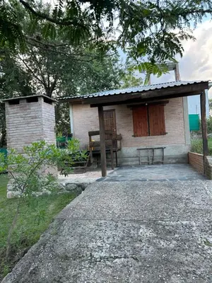 a small house with a bench in front of it at Cabaña Las Marias 4 in Cordoba