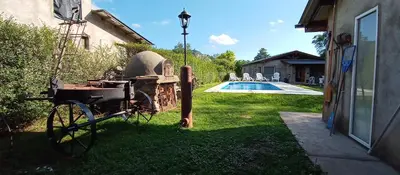 a bike parked in the grass next to a house at Schönes Loft in Villa General Belgrano