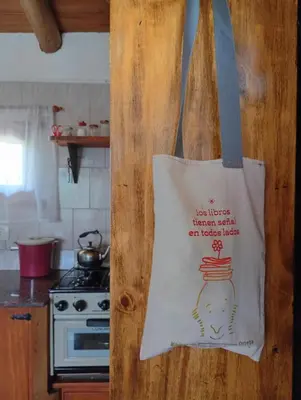 a tote bag hanging on a wall in a kitchen at Cabaña de troncos en Nono, Córdoba in Nono