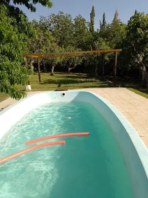 a swimming pool with a red arrow in it at Cabañas Nicasio in Merlo