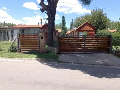 a wooden fence in front of a house at Cabañas Nicasio in Merlo