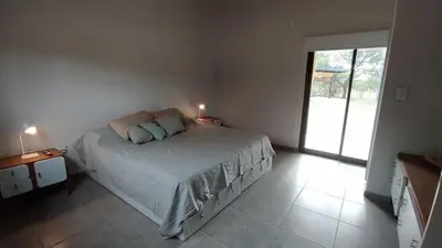 a bedroom with a bed and a large window at las tacanas casa del alto in Nono