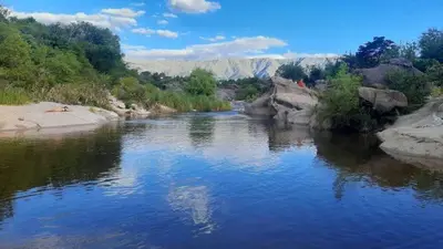 a river with rocks and trees on the side at las tacanas casa del alto in Nono