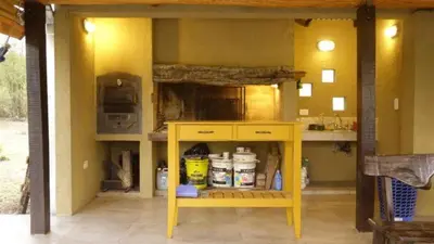 a kitchen with a yellow table in a room at las tacanas casa del alto in Nono